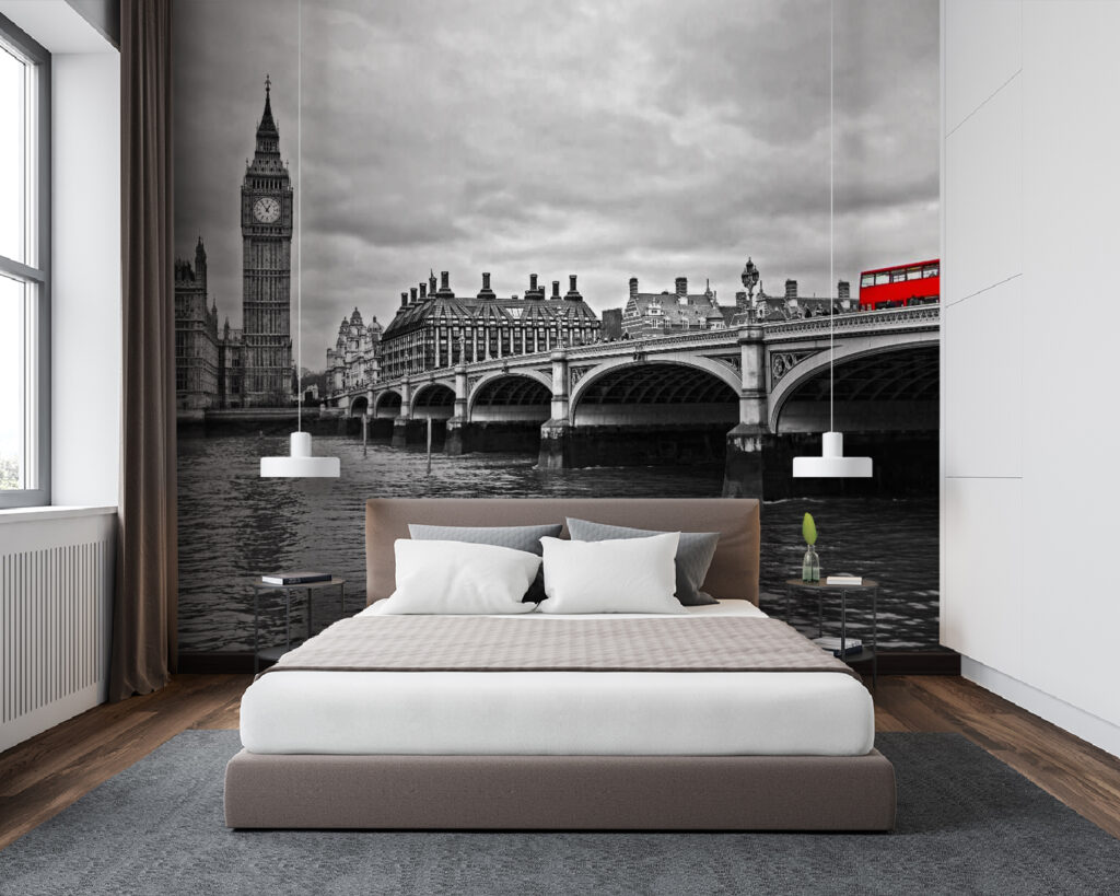 Bridge over water with a clock tower and a red bus