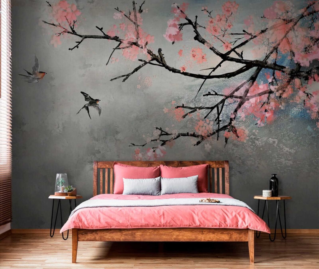 Tree branch with pink flowers and birds flying