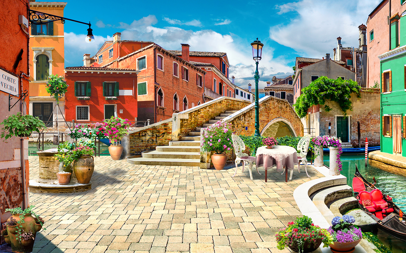 Terasă cu o masă și scaune și o fântână în fața unei clădiri u18551p - Terasă cu o masă și scaune și o fântână în fața unei clădiri - tegory