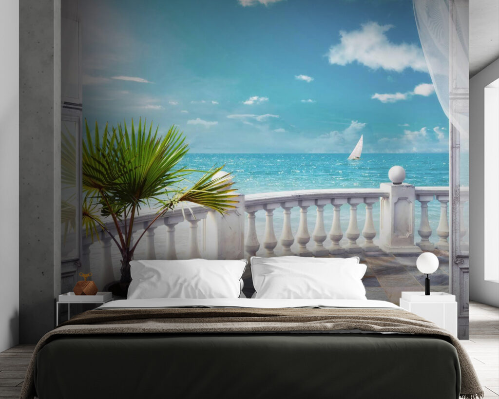 Balcony with a palm tree and a sailboat in the water