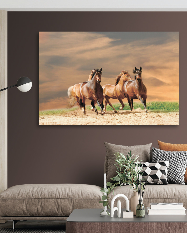 A group of horses running on a dirt road A group of horses running on a dirt road