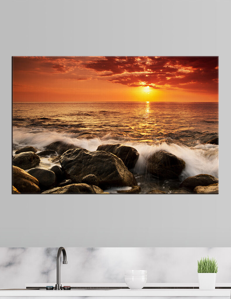 A sunset over a rocky beach