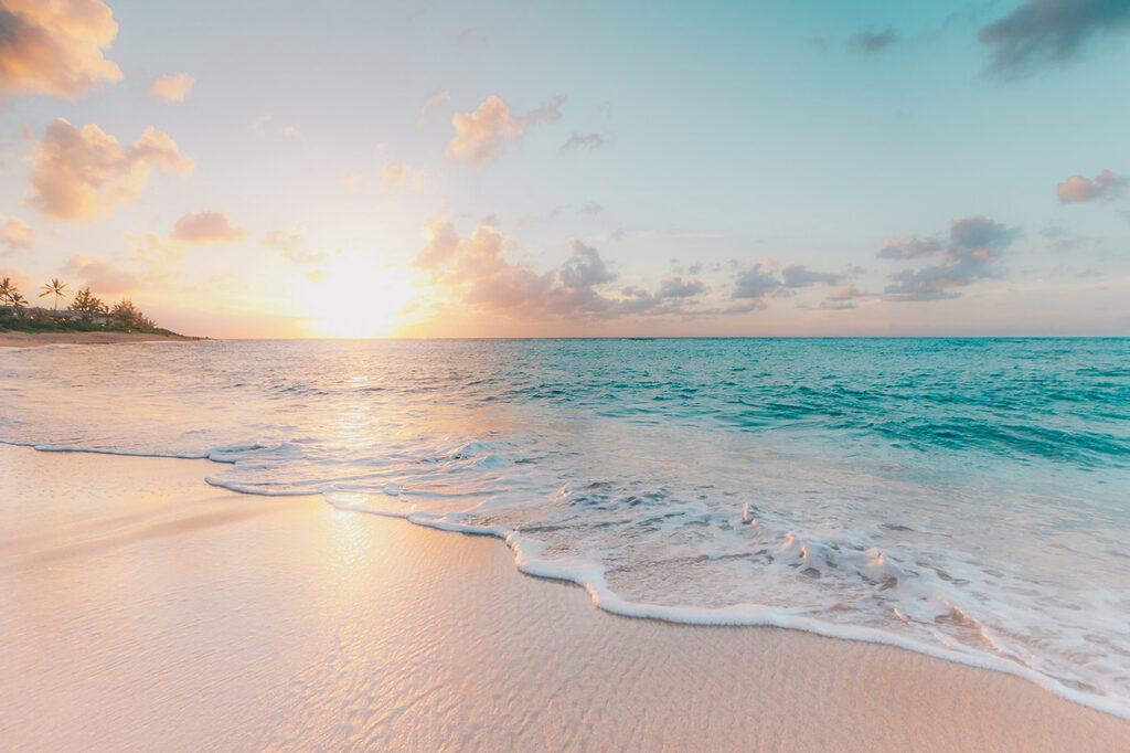 A beach with waves and a sunset A beach with waves and a sunset