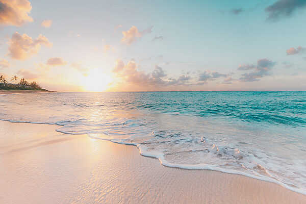 A beach with waves and a sunset A beach with waves and a sunset