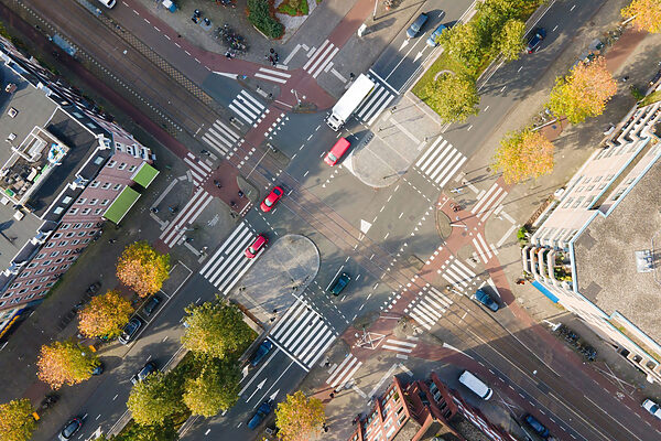 Aerial view of a street intersection with cars and buildings Aerial view of a street intersection with cars and buildings