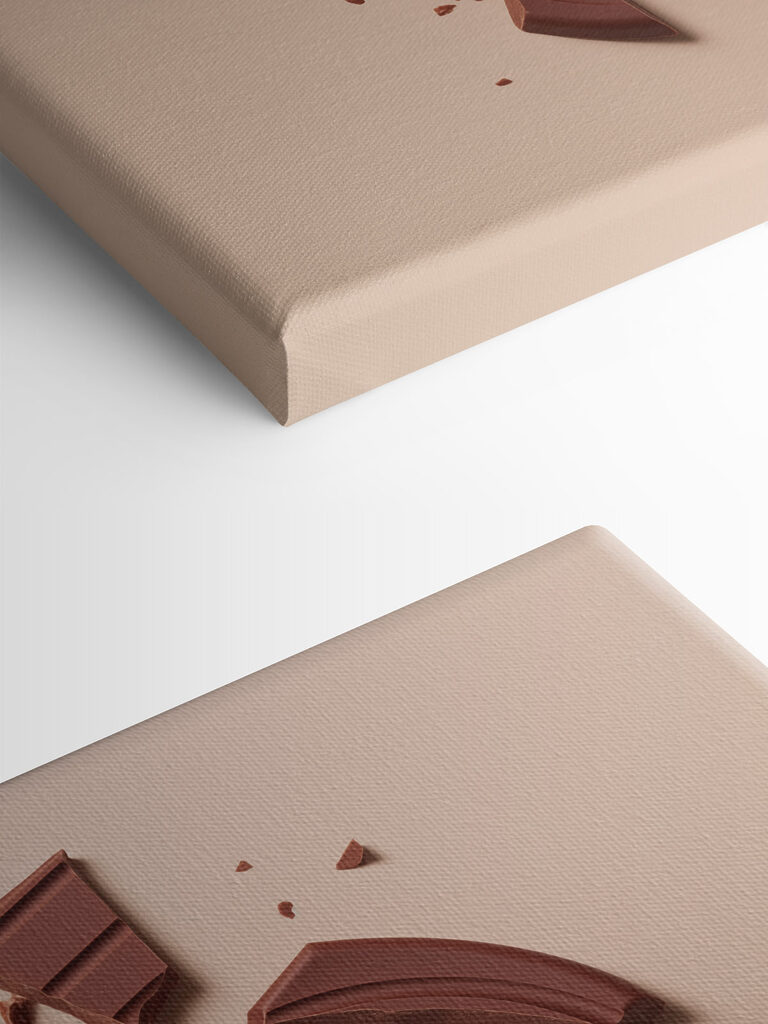 Broken chocolate bar on a pink surface