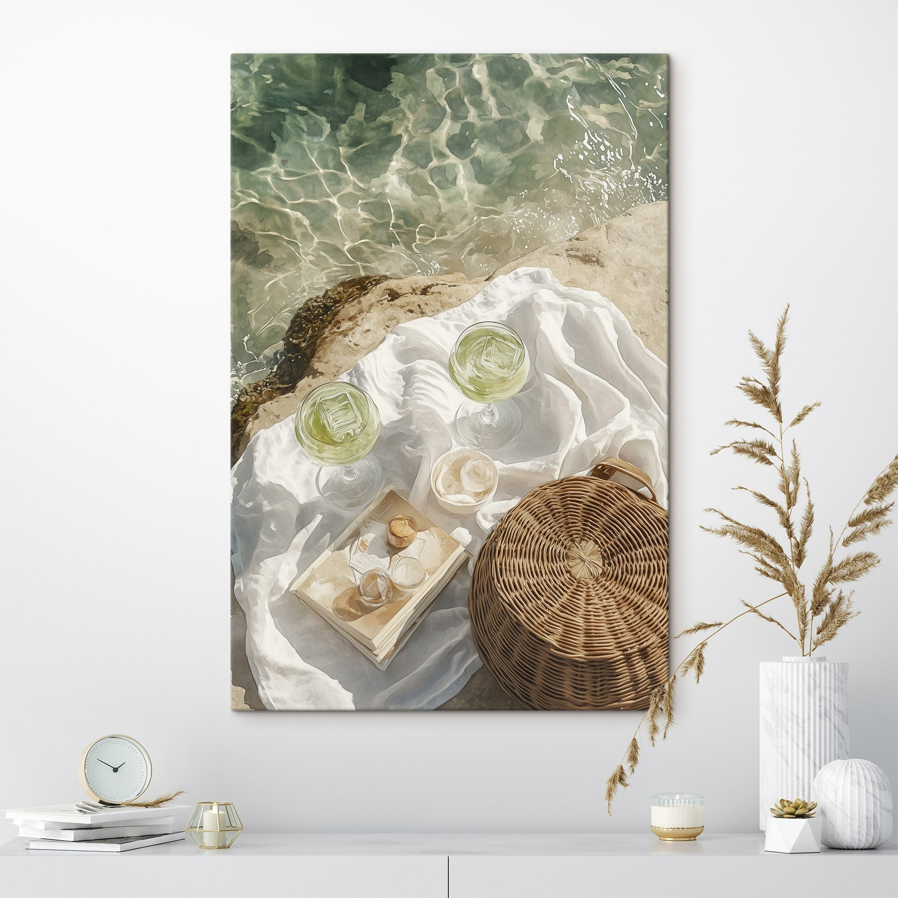 Picnic basket and glasses of wine on a rock by water