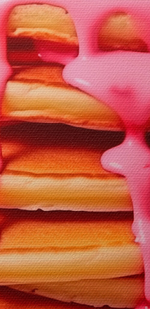 Stack of pancakes with pink frosting and strawberries