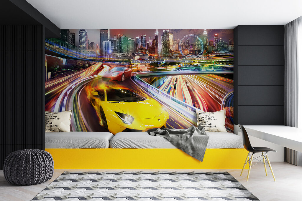 Yellow and red sports cars on a road with a city in the background