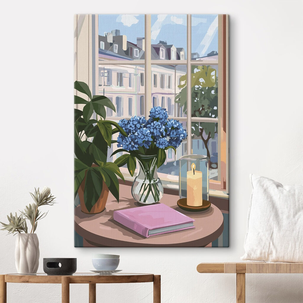 Vase of flowers and a candle in front of a window Vase of flowers and a candle in front of a window
