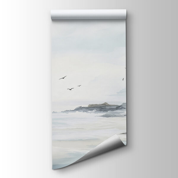 Birds flying over a rocky beach