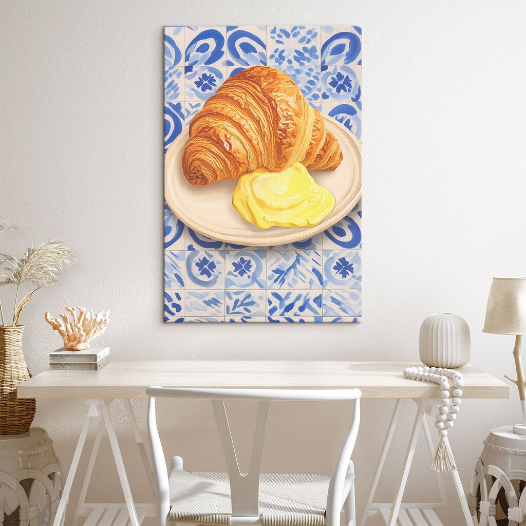 Croissant and a yellow liquid on a plate